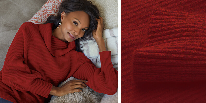 Image of a woman lounging in the red Calanthe Cashmere Pullover